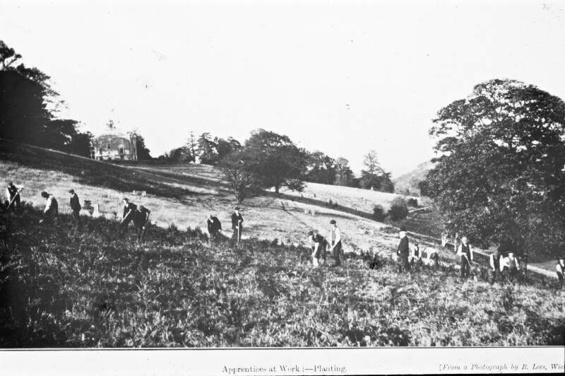 From a publication: 'Apprentices at work: Planting'. All youth, older man in bowler hat. House/institution in background.
