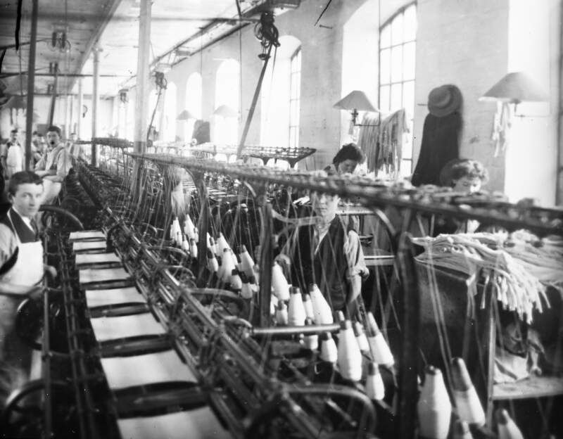 Technology and spools: men and women at looms.