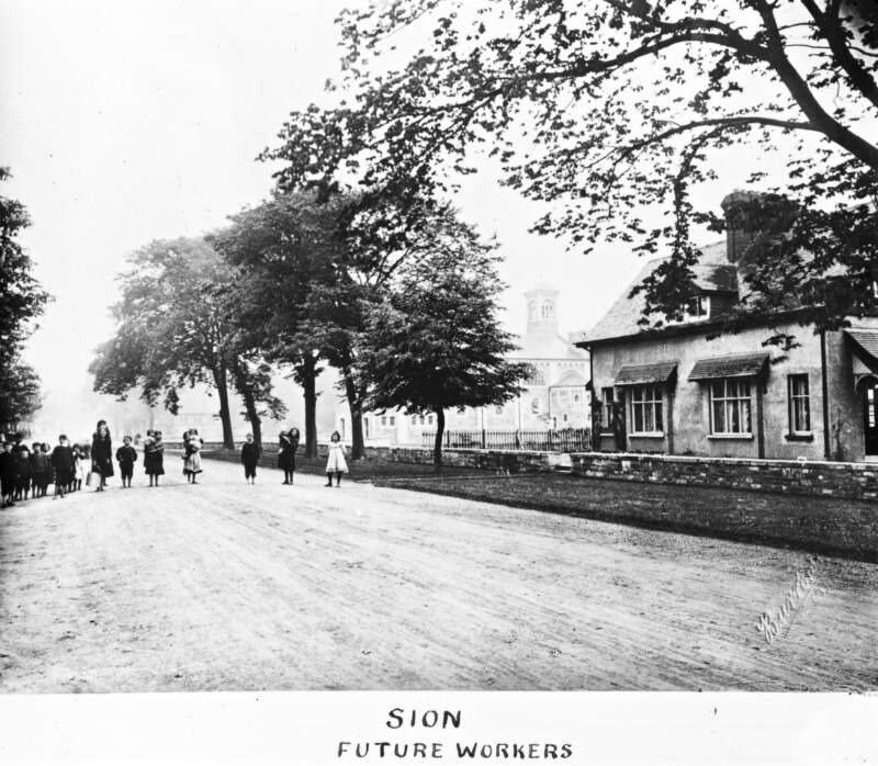 Sion: Label, 'Future Workers'; line of children on road.