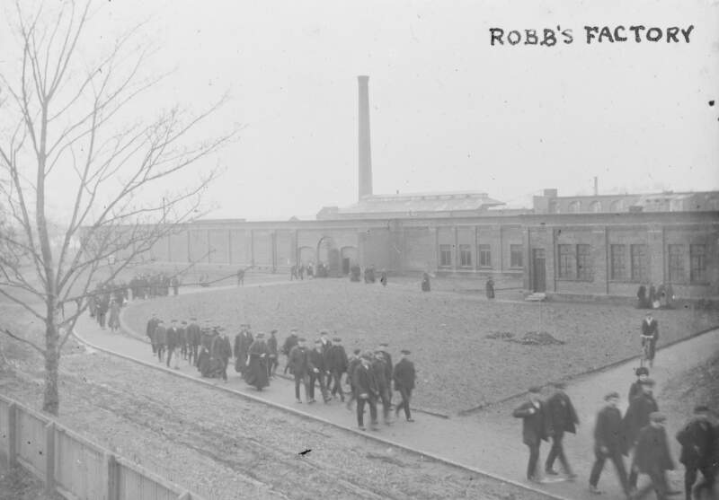 Robb's Factory: men, women and youth leaving building.