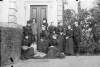 [Large group outside Clonbrock House - two men and eight women. Includes elderly women and a teenage girl. Luke Gerald Dillon on left with daughter Ethel]