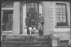 [Two men with guns, dressed in hunting attire on steps of Clonbrock House, setter type dog and fowl also included.]