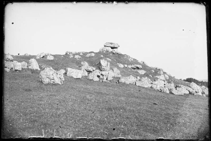 [11/81. Dolmen on top of hill surrounded by rocks/boulders.]