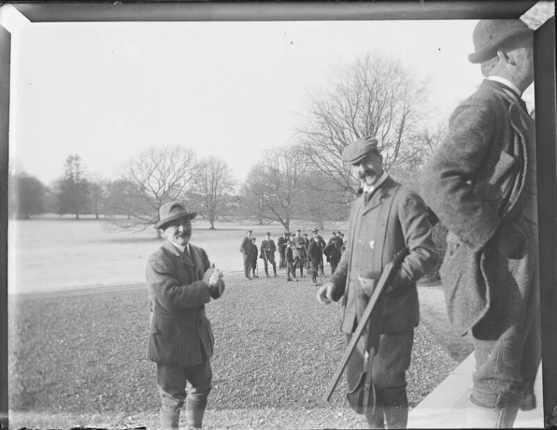 [Shooting party on parklands in front of Clonbrock House. Two men in foreground, one identified in "Ex-camera" as Lord Ardilaun.]