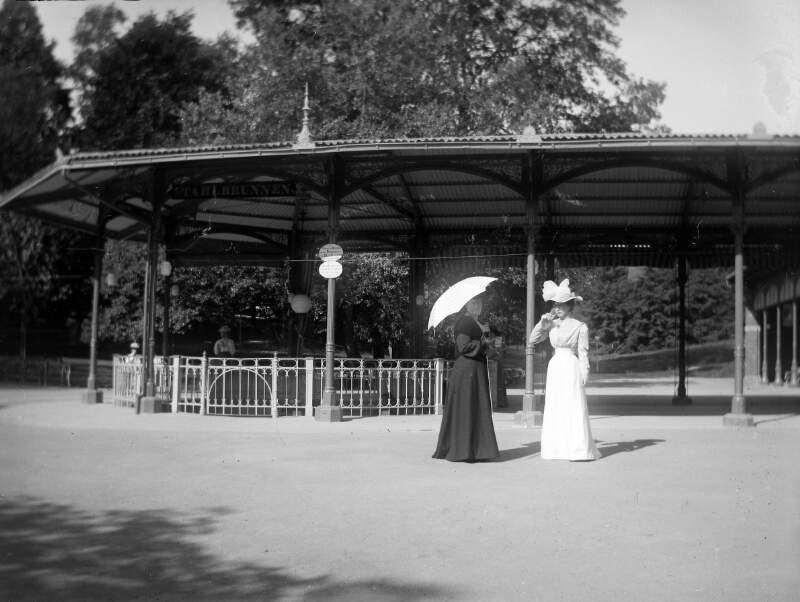[Schwalbath, Georgy and Miss Brodie drinking, June 27th 1901. Two women in park near bandstand. One carries parasol Georgina(b.1867) Dillon, similar to Clonbrock 650.]