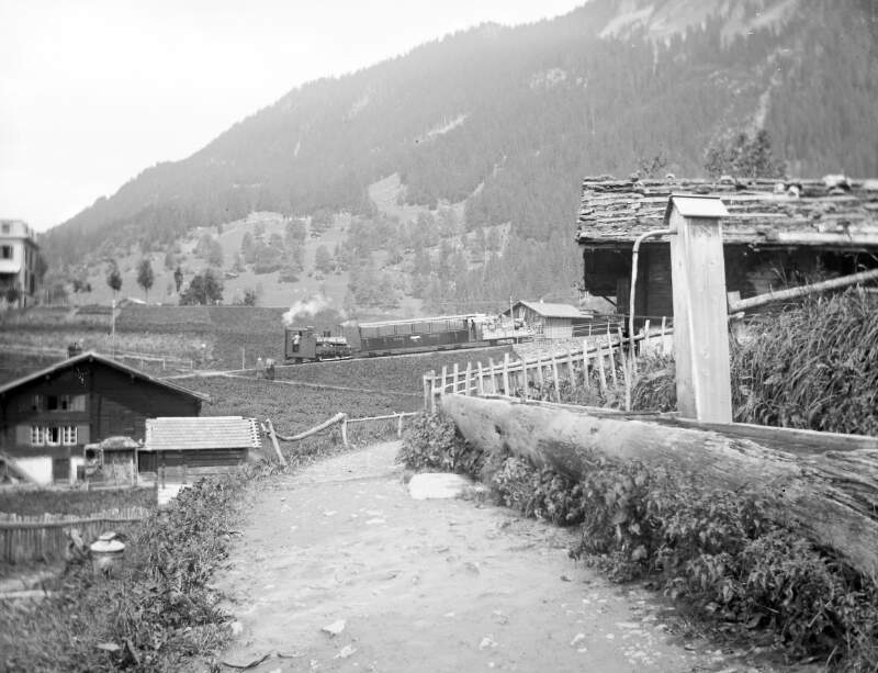 [Pump 7th August 1901. Pump by side of track in valley, several Chalets also visible.]