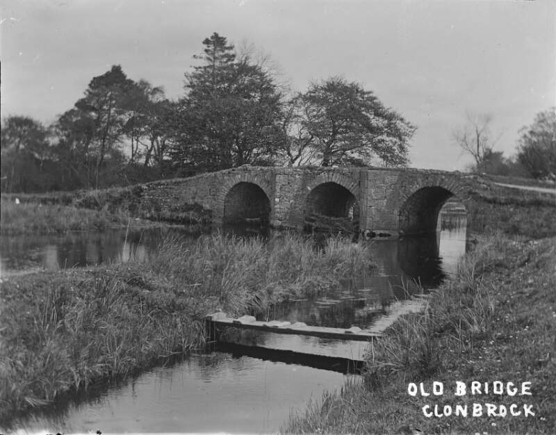 [Oldbridge, Clonbrock 1903. Three arched stone bridges over river. Reeds and grasses in foreground. Trees in distance.]