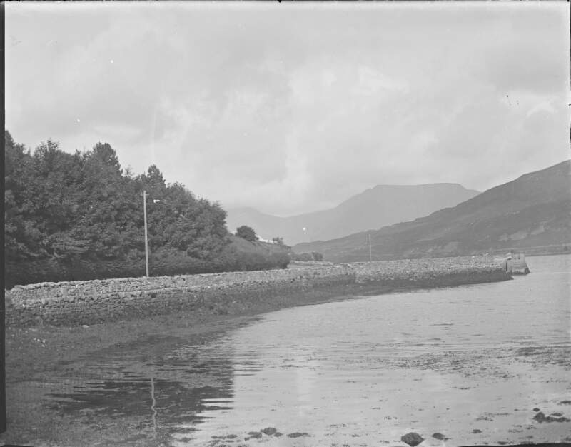 [Galway by Edward 2 of 8. View of inlet surrounded by mountain, stone walls along roadside.]