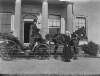 [Coach 1926. Open horse drawn carriage in front of Clonbrock House, man in uniform driving carriage, woman seated behind. Augusta Crofton Dillon standing on gravel driveway.]