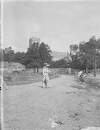 [Boxhill/Christ Church. Woman with parasol on path with the church from Clonbrock 1414 in the distance.]