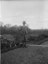 [Man standing by plants and steps leading down a pathway, possibly Luke Mahon.]