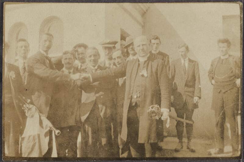 [Eamon De Valera shaking hands with a clergyman, location unclear],