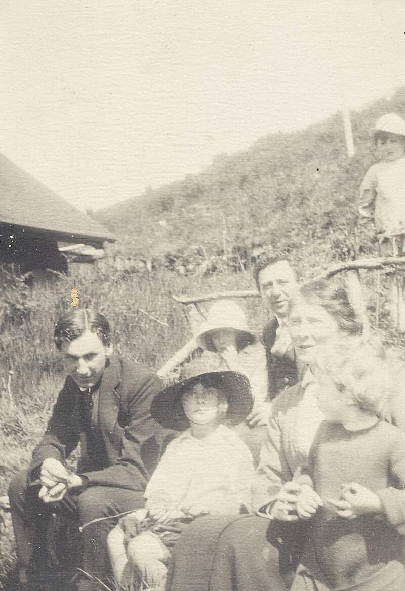 [Thomas MacDonagh and Donagh MacDonagh, with a group of friends including children, seated outdoors]