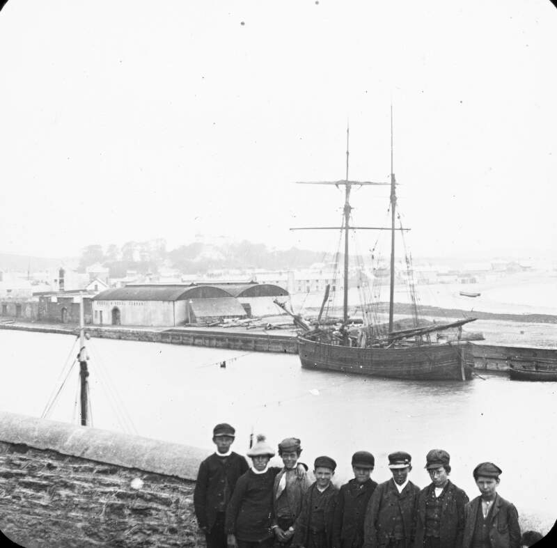 Wicklow, boys in hats at harbour, with boat, Co. Wicklow