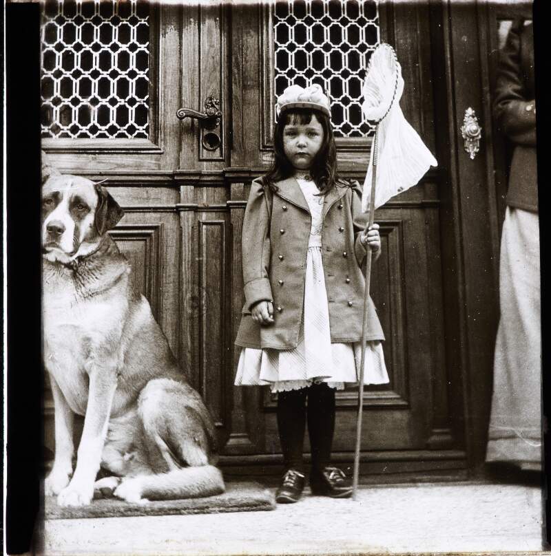 Girl standing with dog and carrying net