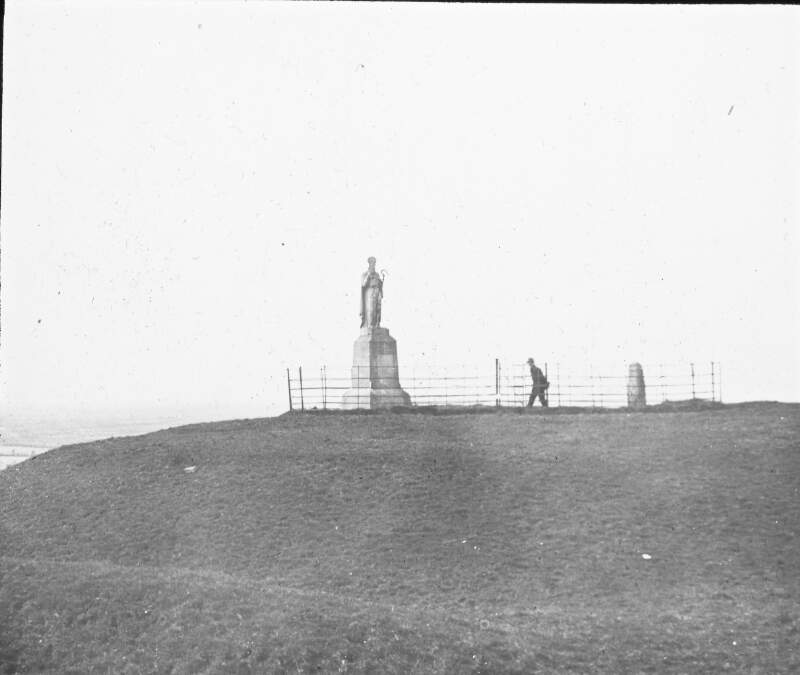 Tara Hill with statue of Saint Patrick, with figures observing.