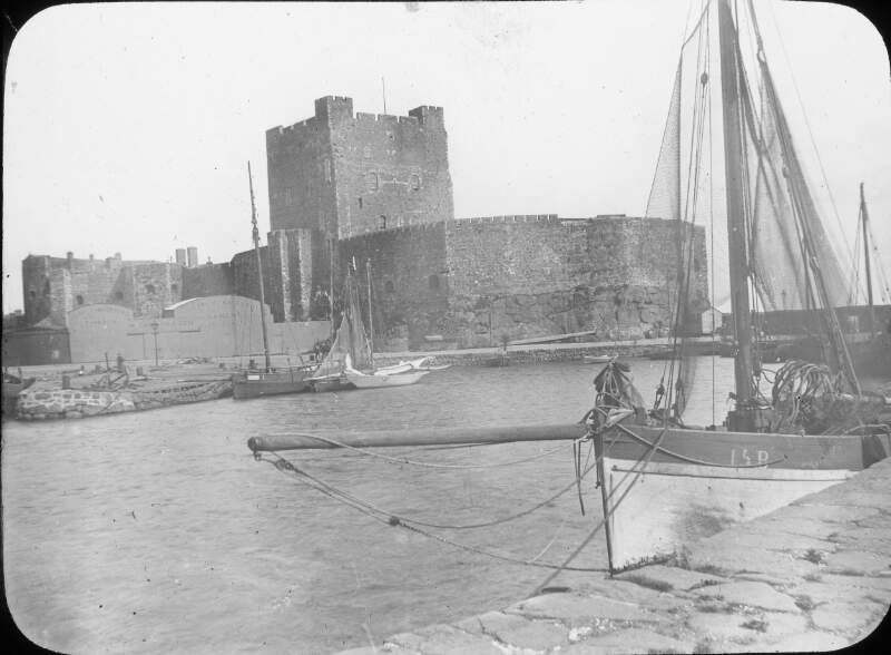 Carrickfergus Castle, warehouse 'Gorman & Son' in foreground.
