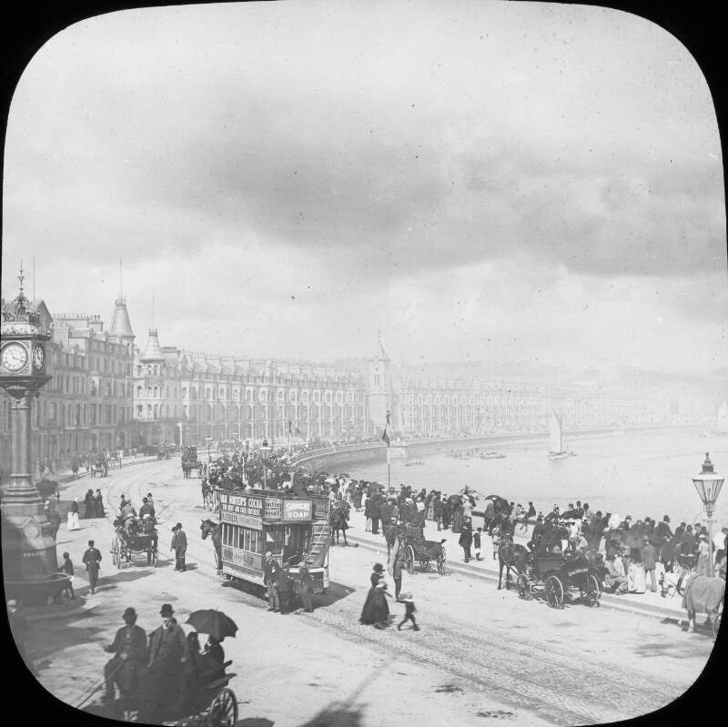 The esplanade at Douglas on the Isle of Man, with trams, shops, and many people strolling.
