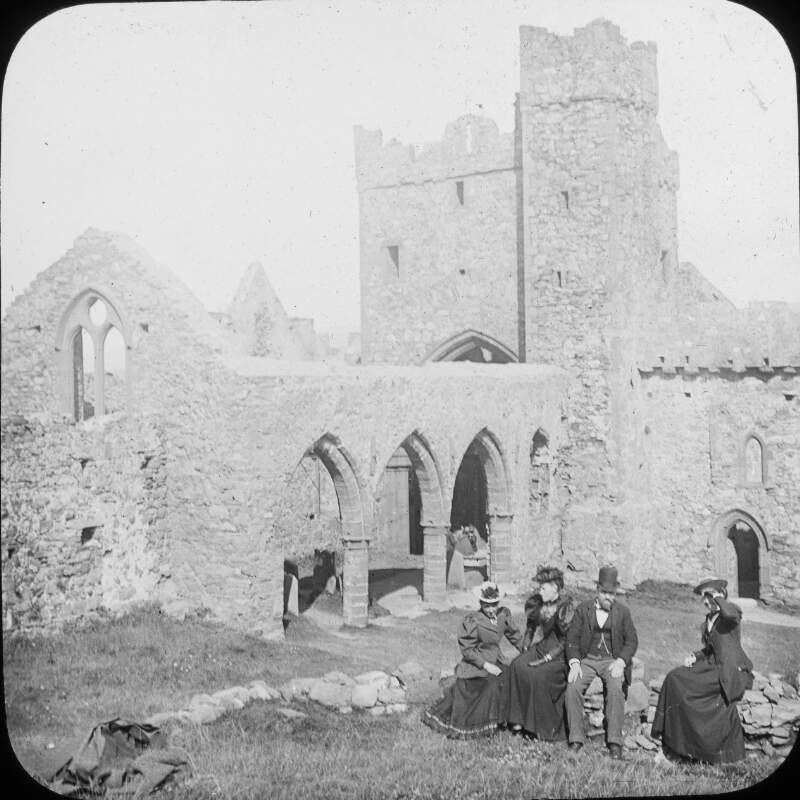 Ruins of the Cathedral, Peel. Four figures, Edwardian dress.