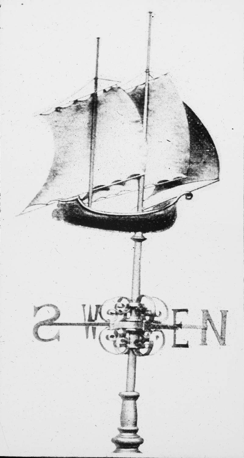 Decorative ship, with sails, as wind guide on top of compass points.