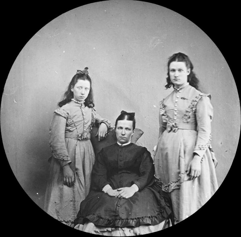 Formal portrait. Woman with two daughters - strong familial resemblance.