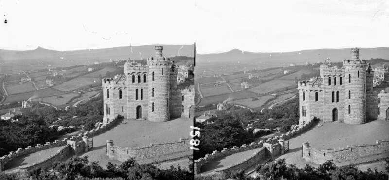 Gothic style modern castle in foreground, open landscape in middle ground, Sugar Loaf in background, Killiney, Co. Dublin