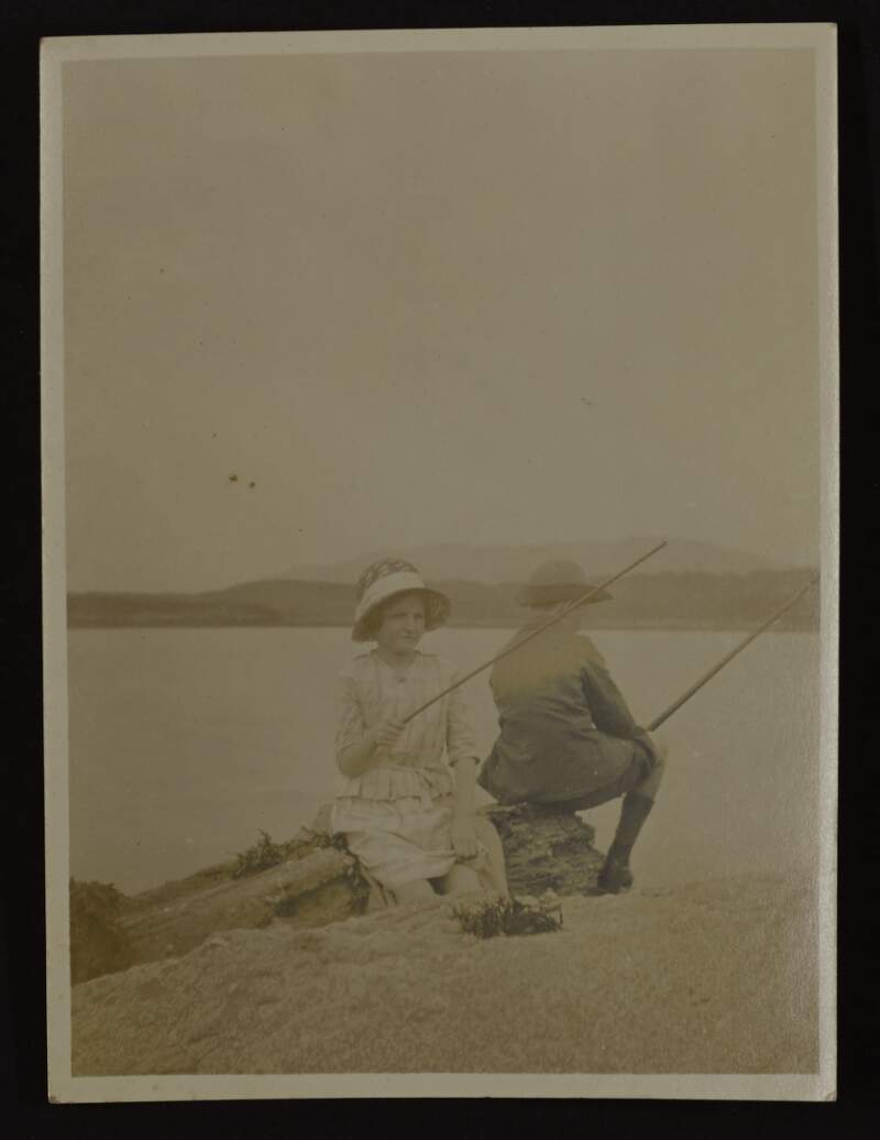 [Girl and boy fishing at seaside]