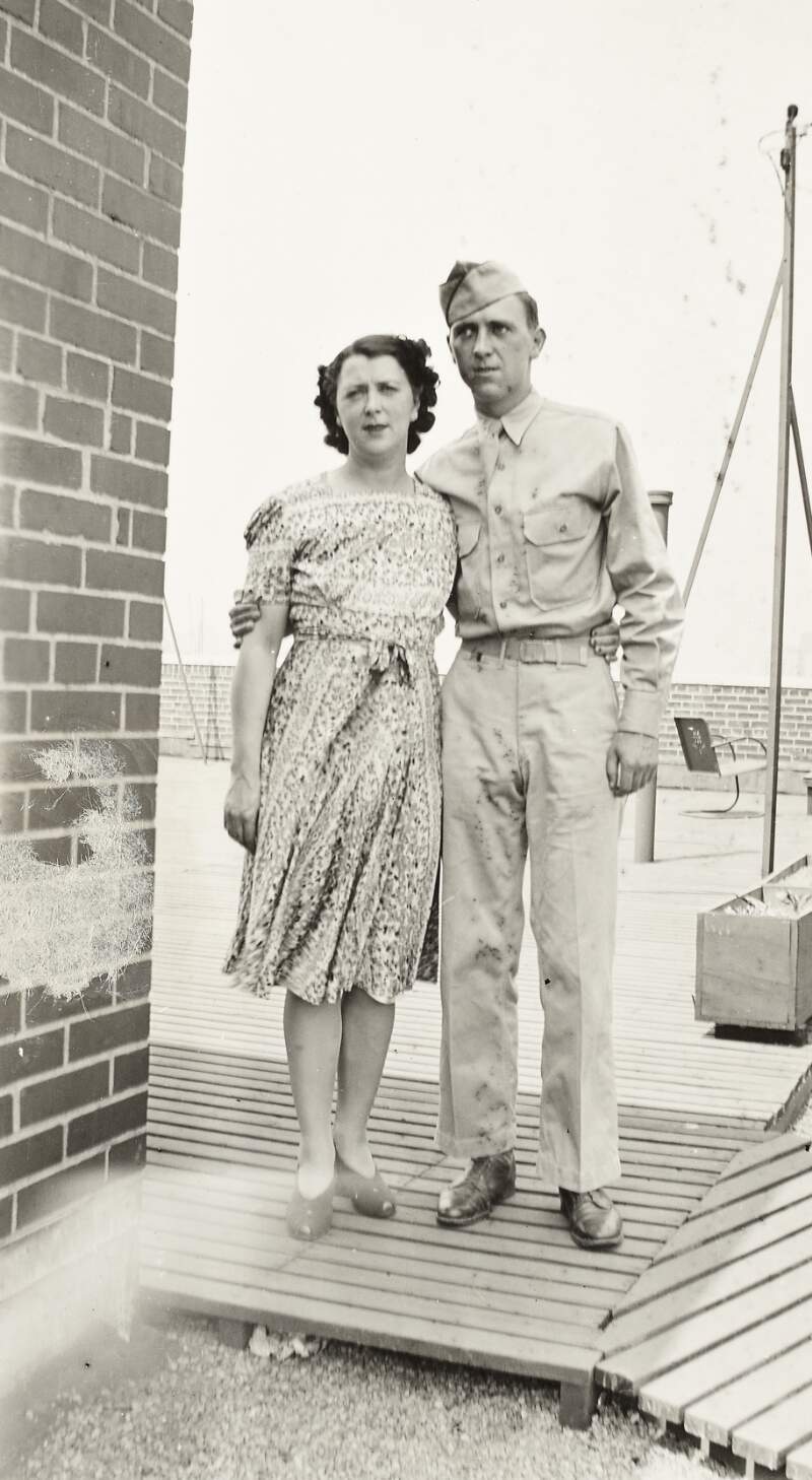 [Man in military uniform [possibly Tim Carson] with unidentified woman, on roof-top, full-length portrait, location unidentified]