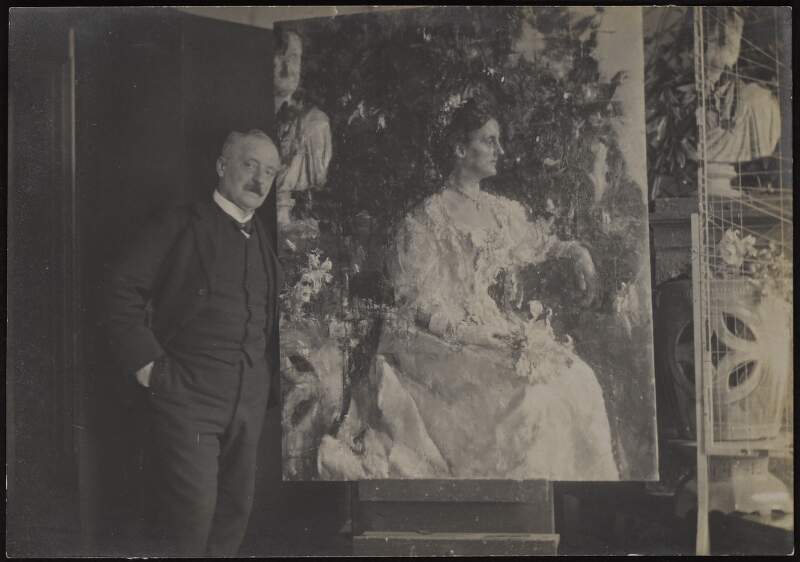 Photograph consisting of Antonio Mancini posing beside his portrait of Mrs. Shine