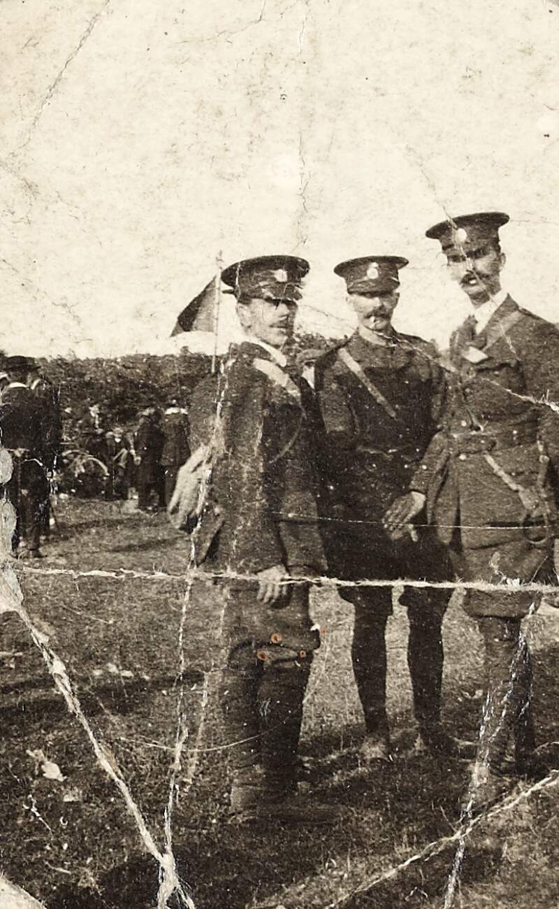 [Eamonn Ceannt in Irish Volunteers uniform with two other soldiers, full-length portrait]