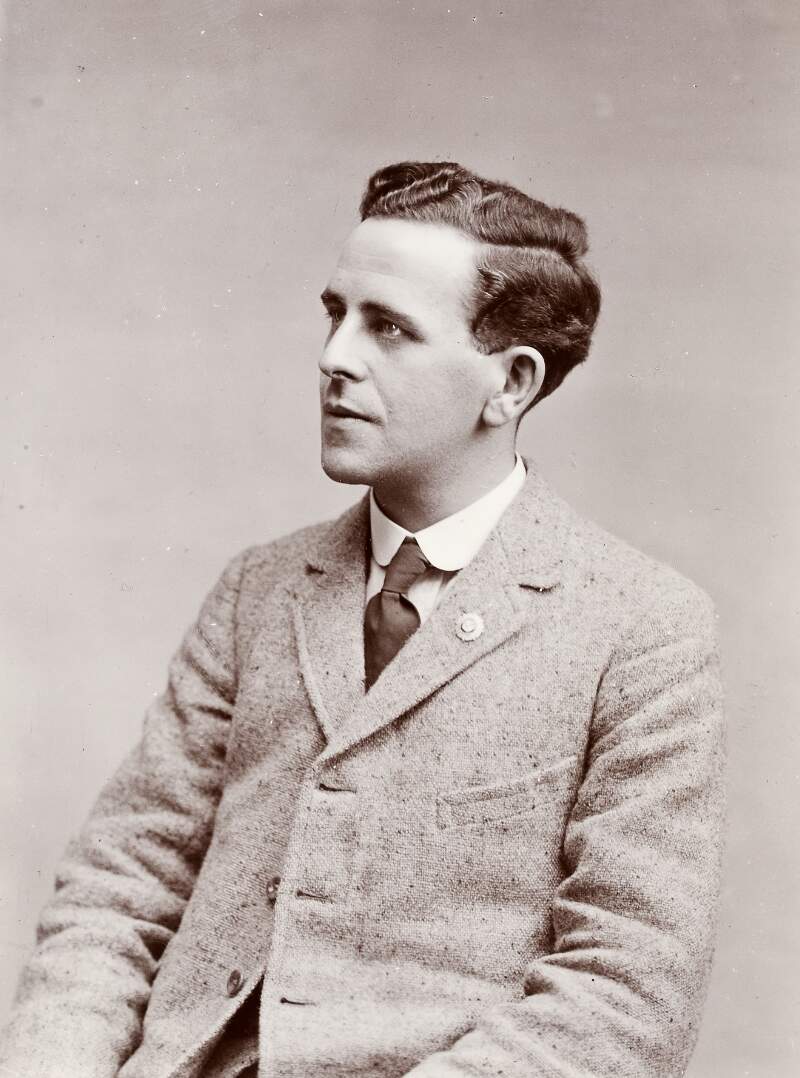 [Sean MacEntee, head and shoulders, profile portrait, seated, in suit and tie]