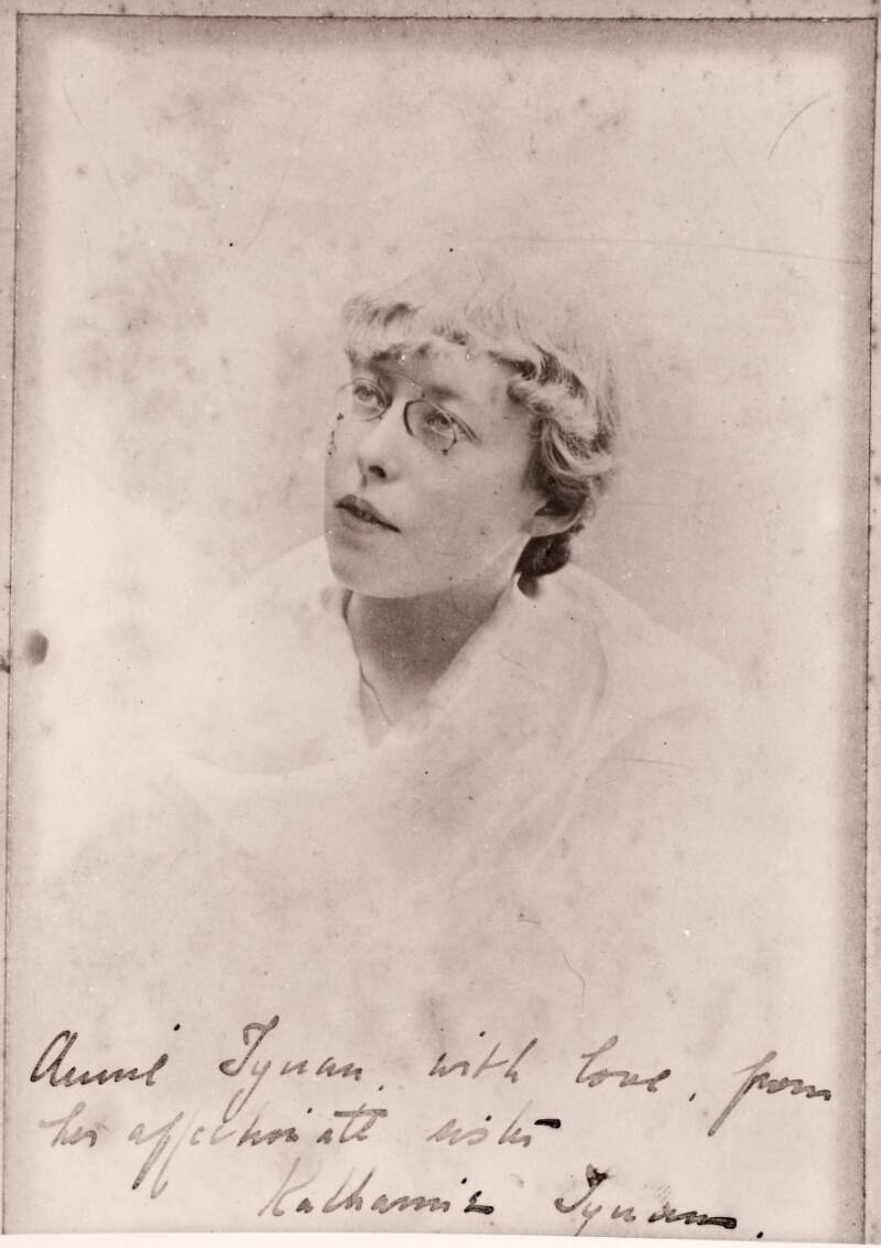 [Head and shoulders, facing left portrait of Katharine Tynan, in eyeglasses and a white shawl]