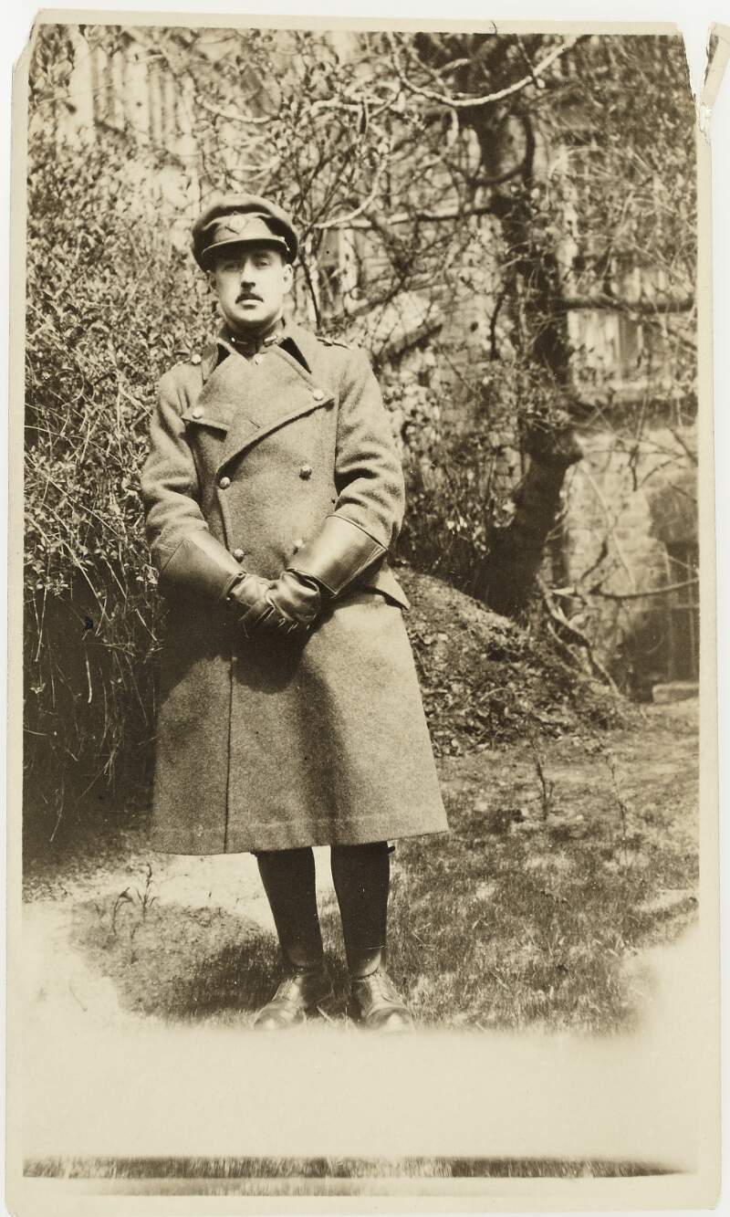 [Unidentified male officer in trench coat and military cap, front facing, full-length portrait]