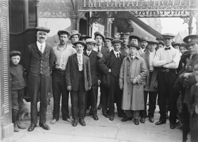 [Survivors of the Lusitania disaster, Co. Cork : group of men and possibly crew, standing outside the 'Imperial Hotel']