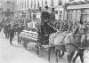 Lusitania disaster, Cobh, Co. Cork : funeral procession headed by a coffin draped in a flag and drawn by horse and carriage]