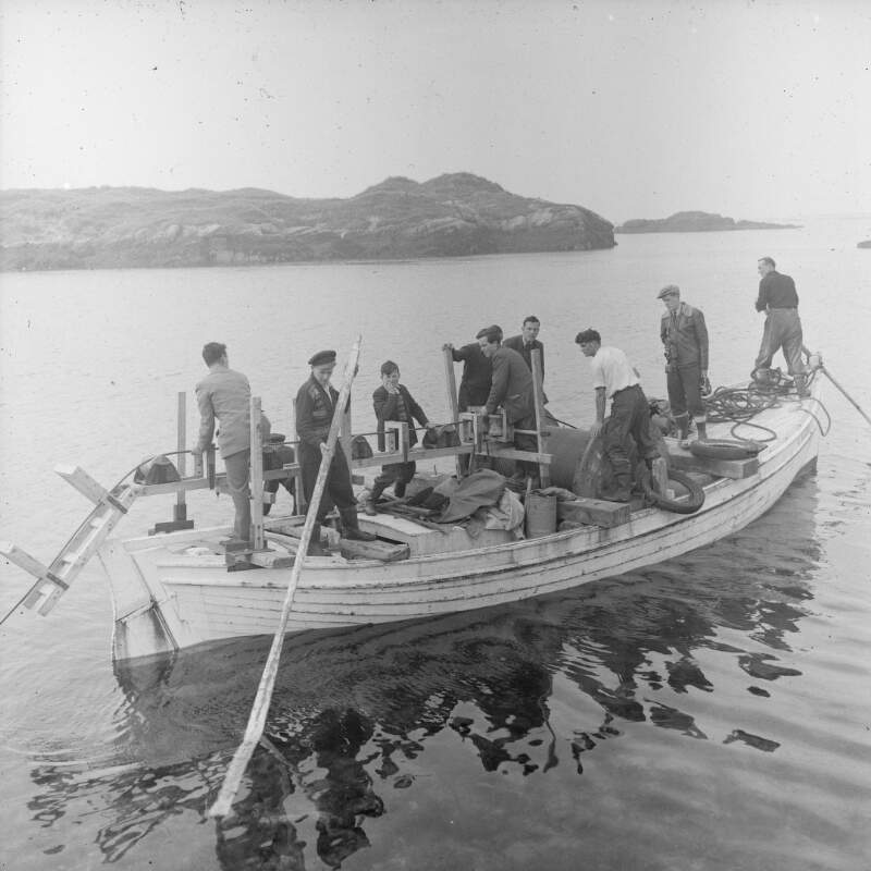 [Men in fishing boat laying a submarine cable to Arranmore Island, Co. Donegal]
