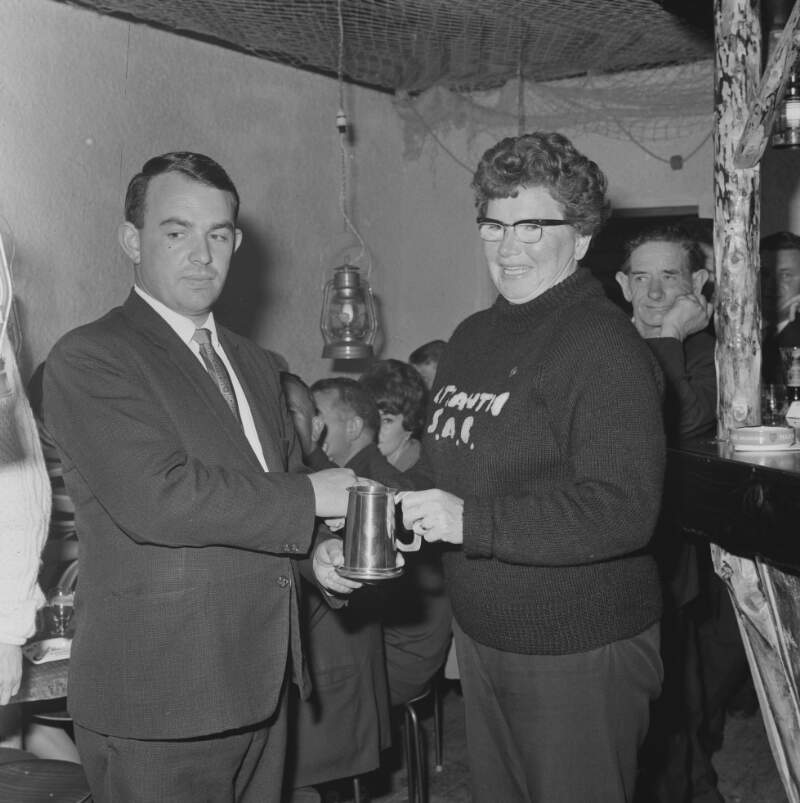 [Woman being presented with award, Burtonport, Co. Donegal]