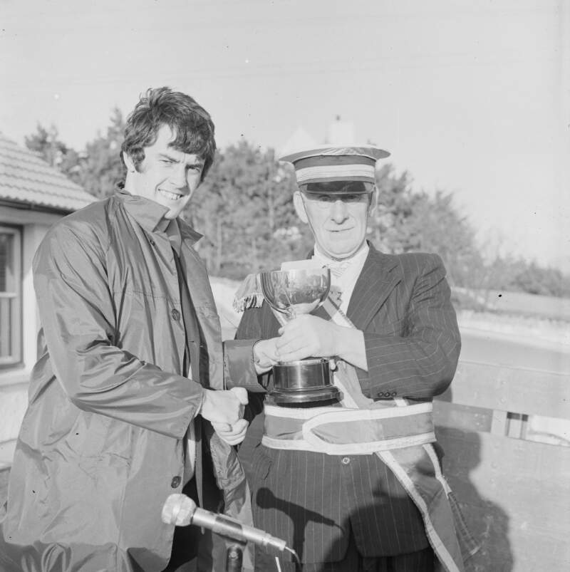 [Male from a marching band receiving trophy at the Easter parade in Dungloe, Co. Donegal]
