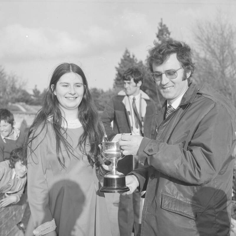 [Man presenting trophy to woman at the Easter Parade in Dungloe, Co. Donegal]