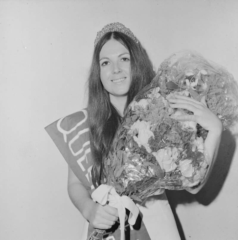 [Female with sash holding flowers, Glenties, Co. Donegal]