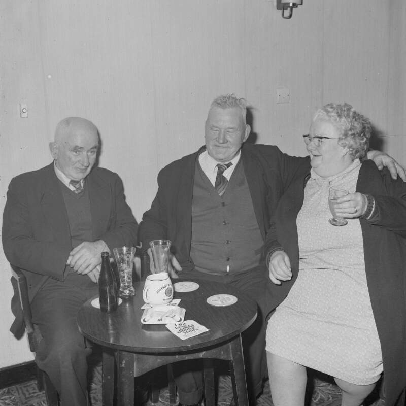 [Woman and men at a party in Glenties, Co. Donegal]
