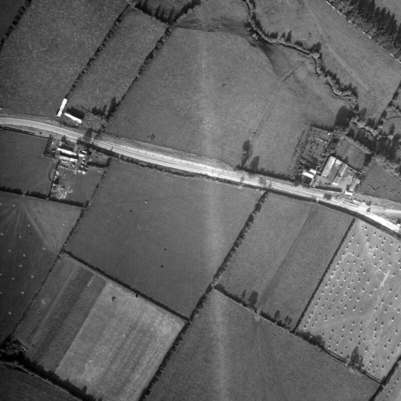 [Aerial photograph of fields and houses]