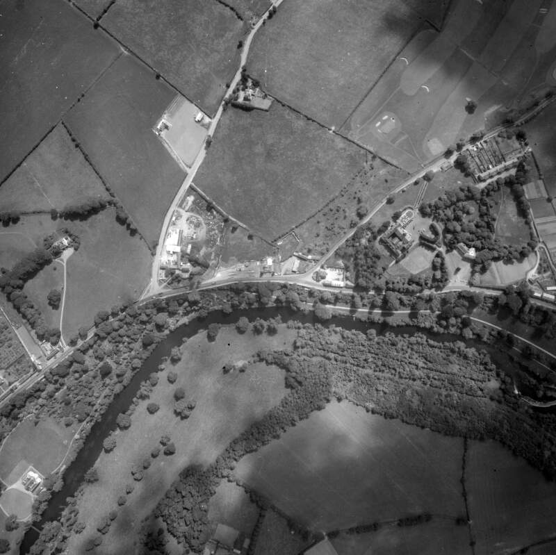 [Aerial photograph of fields and houses]