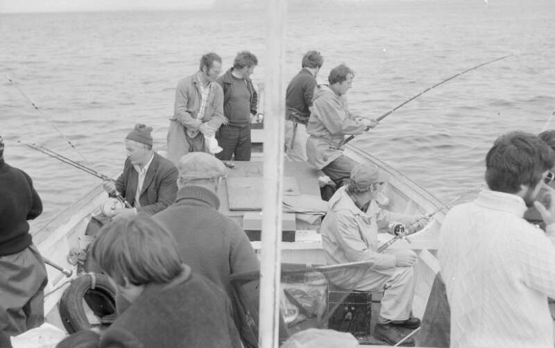 [Anglers on fishing boat at sea, with Tory Island in background, Co. Donegal]