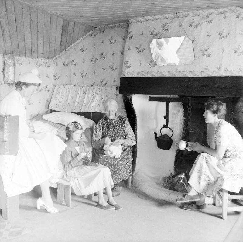 [Women knitting beside the fire in cottage, Lettermacaward, Co. Donegal]