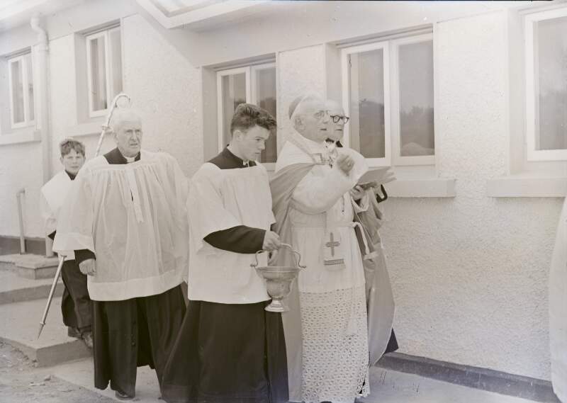 [Members of the clergy walking around building, Co. Donegal]