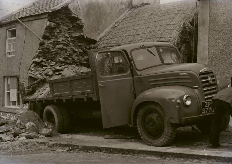 [Truck, beside row of houses, carrying construction materials, Co. Donegal]