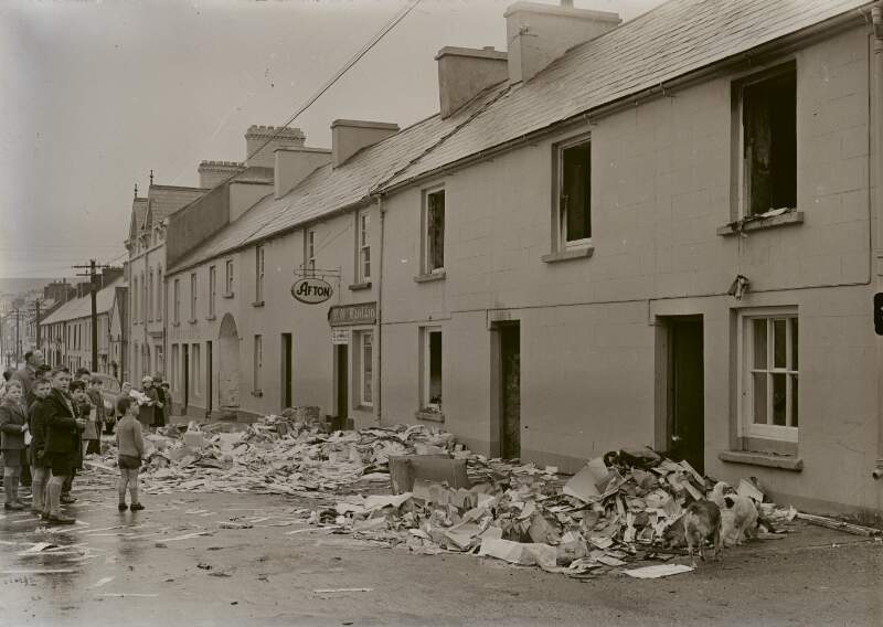 [Group of boys standing round debris on Main Street, Glenties, Co. Donegal]