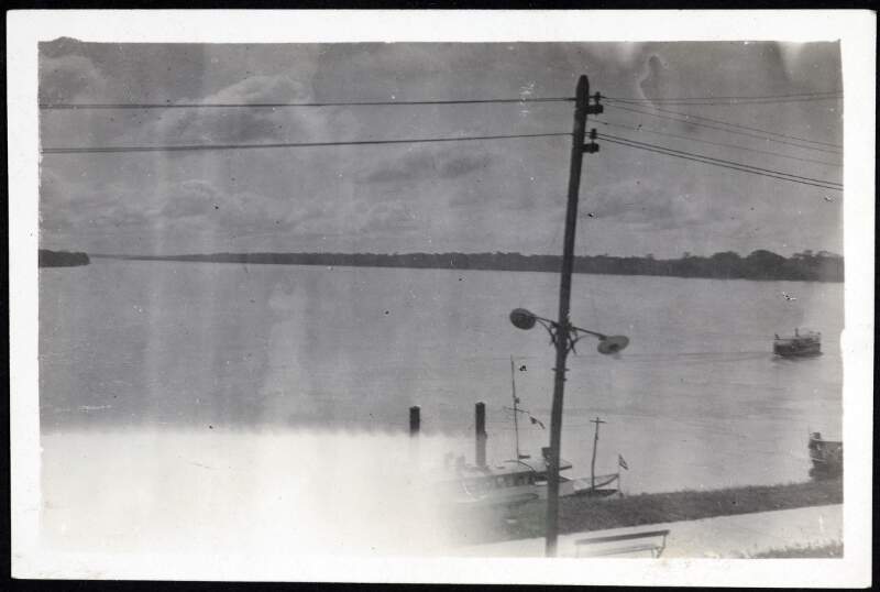 [Telegraph pole in front of a large body of water]