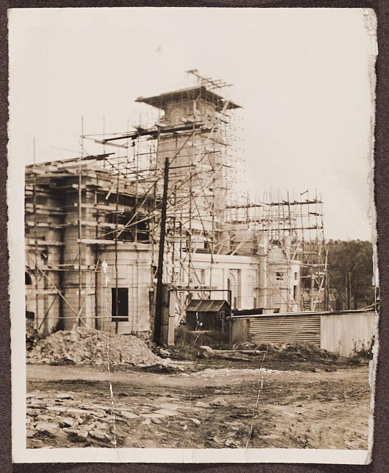 [Partial photo of a building under construction]